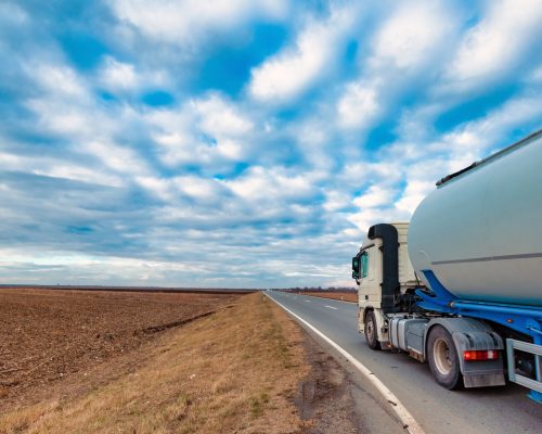 Truck on the road through countryside